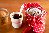 Small Christmas cakes in glasses, served with a cup of coffee