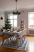 Set dining table in festively decorated dining room