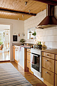 Country-house kitchen with wooden cabinets