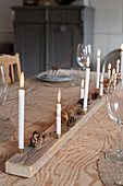 Handmade Christmas decoration made from natural materials and candles on dining table