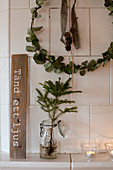 Christmas decorations on white tiled stove