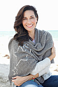 A brunette woman wearing a grey shawl