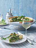 A slice of asparagus quiche on a plate