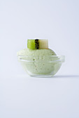 Kiwi sorbet in a glass bowl against a white background