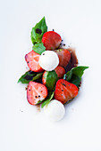 strawberries with balsamic glaze, goat's cheese balls and basil