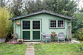 Green summerhouse in autumnal garden