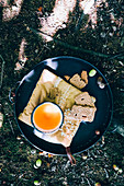 A cup of tea on a tray with Dutch cookies Speculaas on an embroidery fabric in the wood, Autumn mood