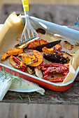 Oven-roasted vegetables with sesame seeds in a baking dish