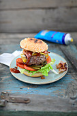 Homemade burger with lettuce, tomatoes, cucumber and cheese