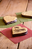 A spelt heart decorated with chocolate writting