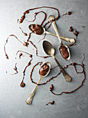 Spoons with chocolate drizzled over them