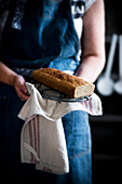 Woman Holding a Homemade Cake with Cloth