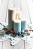 Handmade Advent wreath of paper Christmas trees and four lit candles