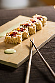 Sweet makis with rice, cardamom and almond paste with a fruity filling