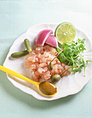 Fish tartare with lime, onion, gherkin and capers