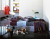 Cushions on couch and dog lying on floor in living room