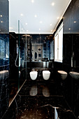 Modern bathroom with glossy black marble cladding