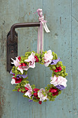 Wreath of peonies, sweet peas and ladies' mantel hung from vintage door handle