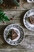 Plate with piece of delicious chocolate cake standing on wooden tabletop