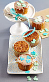 Mini carrot cakes baked in jars decorated with icing and fondant animals