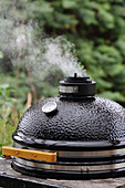 A smoking kettle barbecue