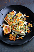Grilled feta with passion fruit and pink peppercorns