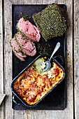 Grilled roast beef with a herb crust and potato-kohlrabi gratin