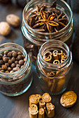 Cinnamon, allspice and star anise in small glass bottles
