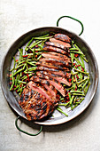 Grilled flank steak with beans and dried tomatoes