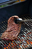 A flat iron steak on a grill