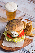 Vegetarian chickpea burger, with fries and a glass of beer
