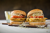 Vegan burger with quinoa, tomato and sprouts