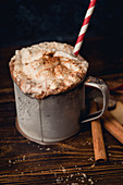 Hot chocolate with whipped cream, cinnamon and cookies