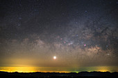 Venus and Milky Way over lights in China