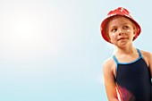 Girl wearing sunhat and suncream