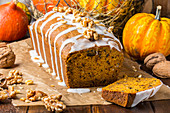 Pumpkin and walnut banana bread on baking paper with icing
