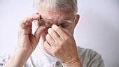 Man with itchy eyes and glasses