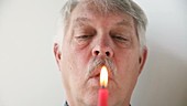 Man blowing on candle