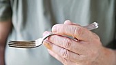 Man holding fork and shaking