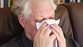 Man with cold wiping nose