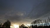 Timelapse of clouds along a frontal clearance at sunset