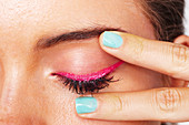 Pink eyeliner on an eyelid