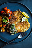 Breaded aubergine schnitzel with tomato salad and capers