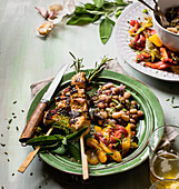 Pork kebabs with beans and roasted peppers