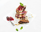 Cottage cheese raspberry pie bars with fresh raspberry jam and meant leaves on a white background