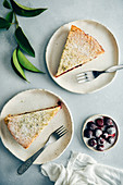 Cherry pie slices served on two white plates with forks on the side