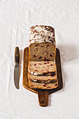 Bread with dried berries, sliced on a wooden board