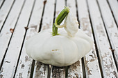 White patty pan squash on a wooden table