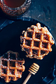 Waffles in a grid with icing sugarand honey