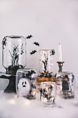 Halloween decorations handmade from jars, branches and cotton wool